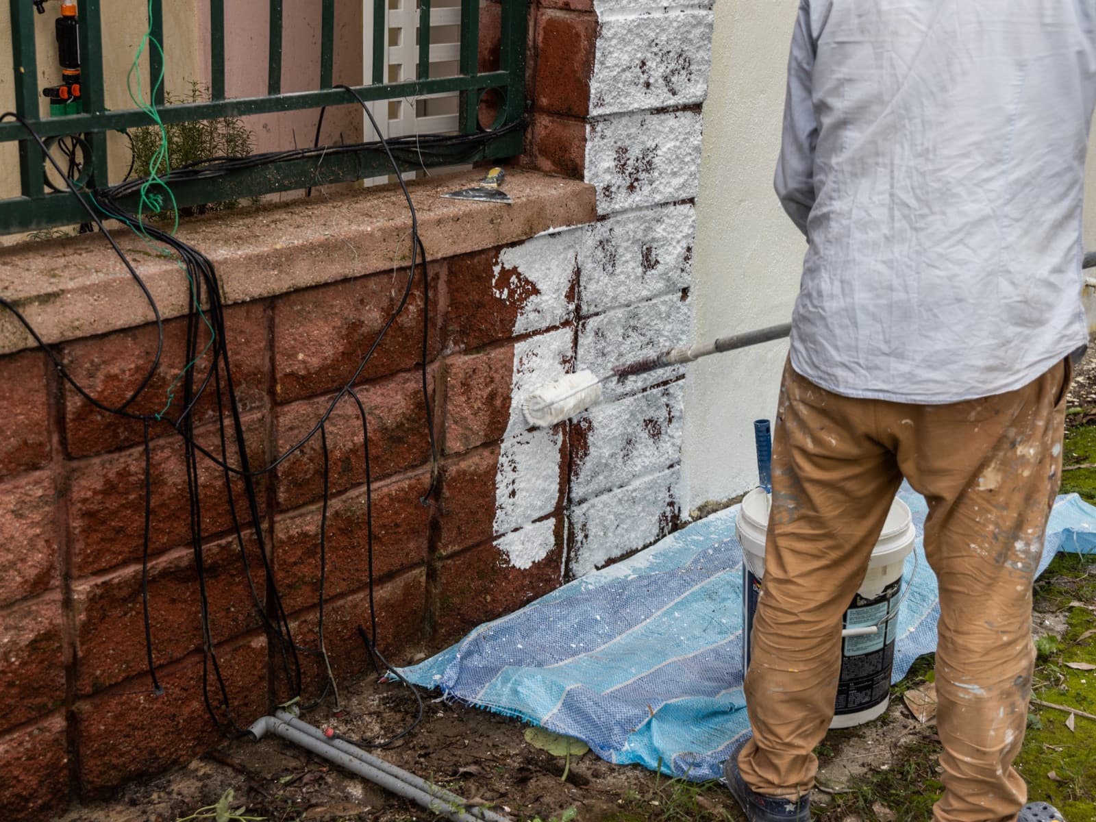Painter worker adding undercoat foundation paint.