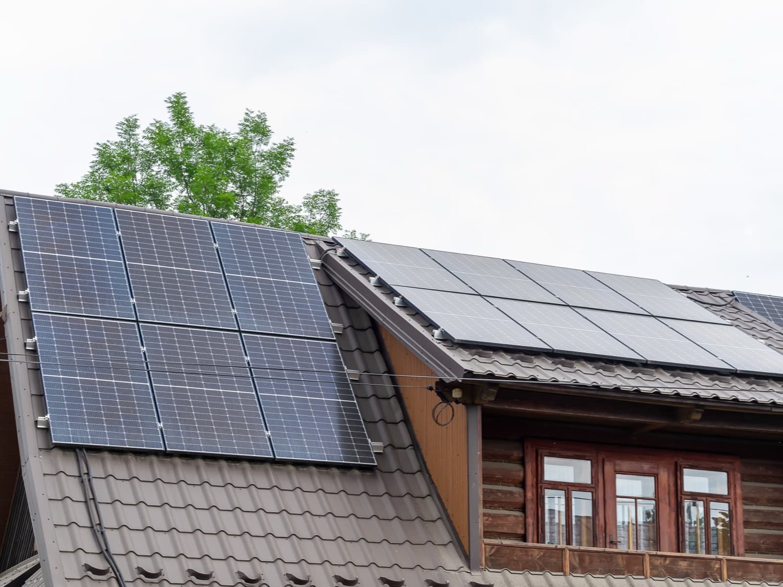 Solar panels on rooftop with windows.