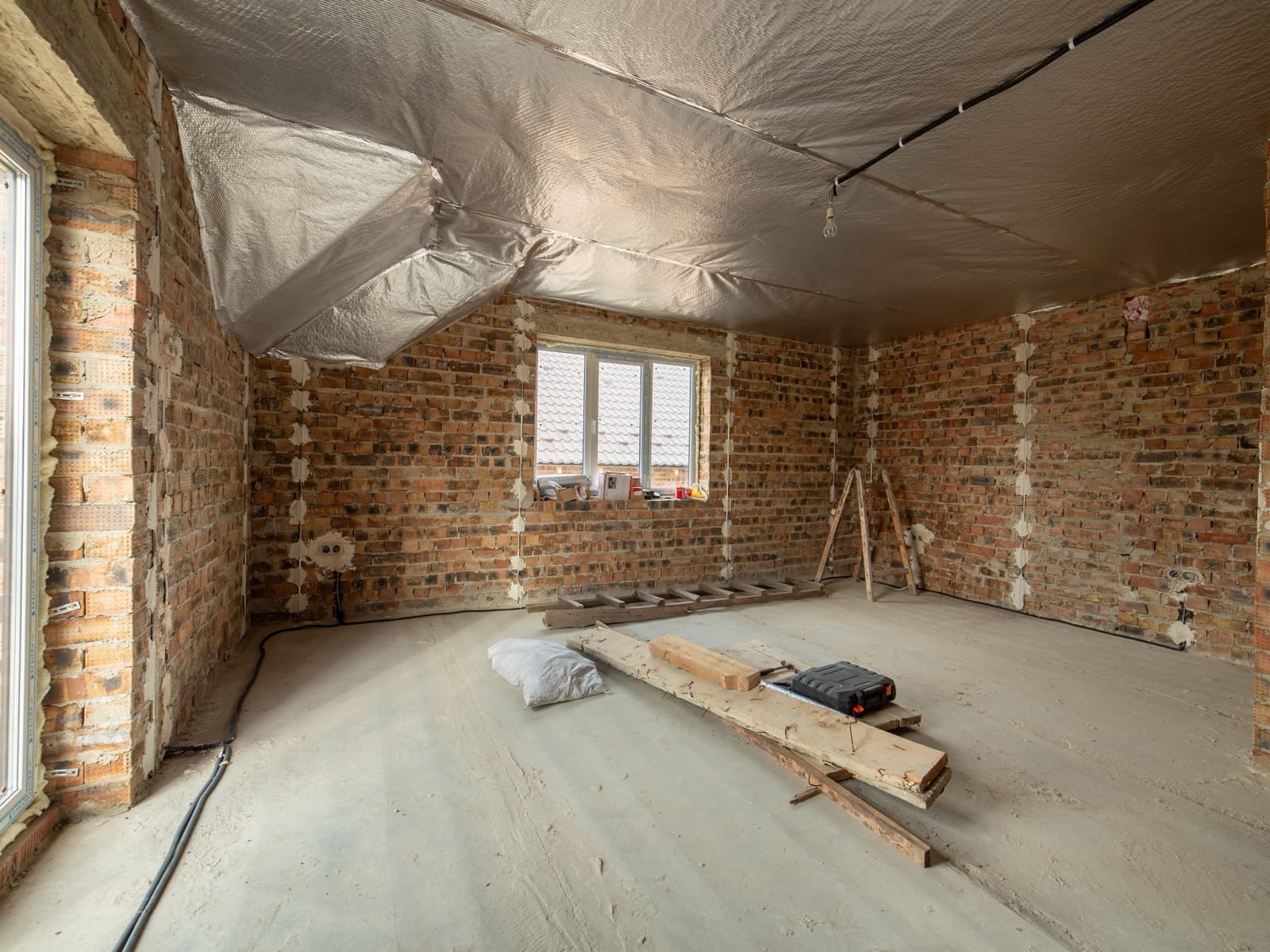 Interior construction project with exposed brick.